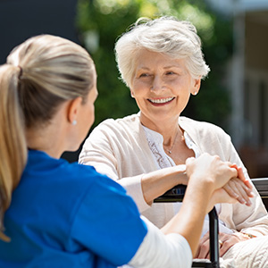 Health profesional talking with elderly patient